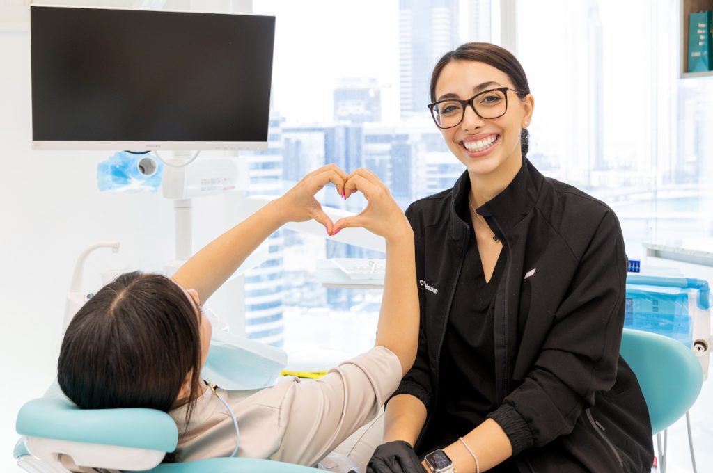 Dentist and patient during a dental consultation in a modern clinic in Dubai.