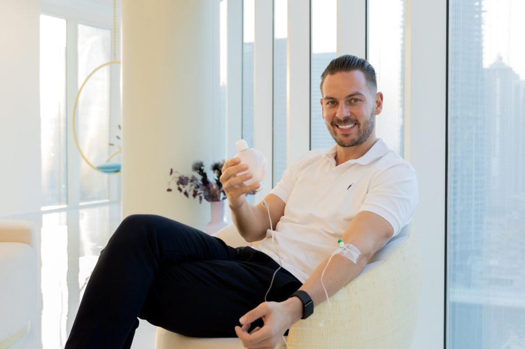 Patient receiving an intravenous longevity treatment in a modern Dubai clinic.